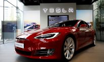 On the Road to Make an Affordable Car, Tesla Cuts Jobs