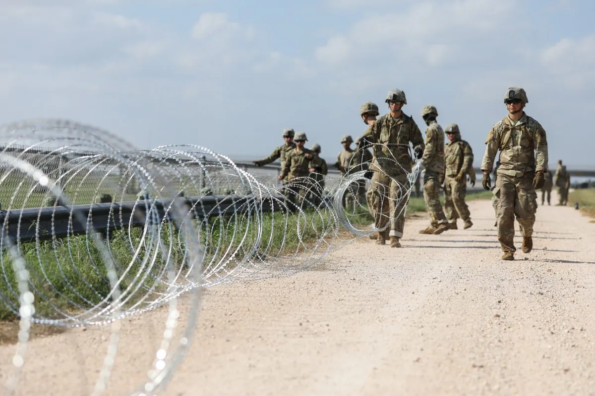 The U.S. military installs concertina wire on the levee behind Granjeno in Texas, just north of the U.S.-Mexico border on Nov. 7, 2018. (Samira Bouaou/The Epoch Times)