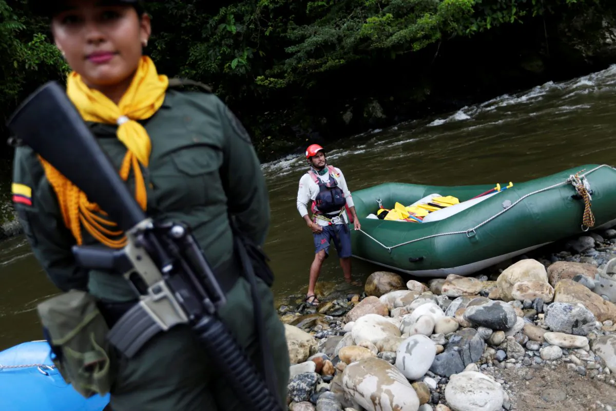 A police woman escorts an inflatable raft in Miravalle, Colombia on Nov. 9, 2018. (Luisa Gonzalez/Reuters)