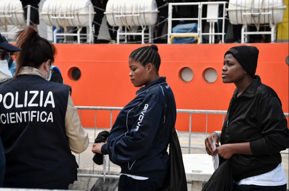 A Nigerian woman and other migrants disembark from the MV Aquarius on its arrival at the Sicilian port of Messina, on May 14, 2018. (Louisa Gouliamaki/AFP/Getty Images)
