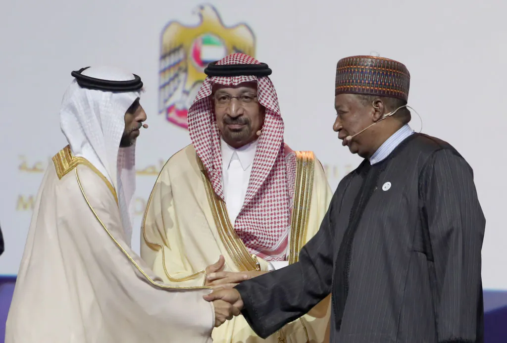 The UAE Energy Minister Suhail Mohammed Faraj al-Mazroui (L) shakes hands with OPEC Secretary General Mohammed Barkindo (R) watched by Saudi Energy Minister Khalid al-Falih (C) during the Abu Dhabi International Petroleum Exhibition and Conference (ADIPEC) in the Emirati capital Abu Dhabi, on Nov. 12, 2018.(KARIM SAHIB/AFP/Getty Images)