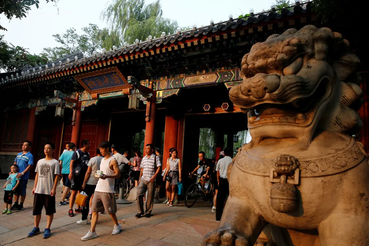 People enter and leave the gate of Peking University in Beijing on July 27, 2016. (Thomas Peter/Reuters)