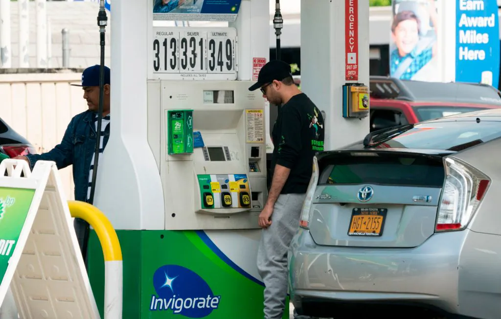 Customers pump gasoline into their cars at a gas station in the Bronx, New York, on June 1, 2018. (DON EMMERT/AFP/Getty Images)