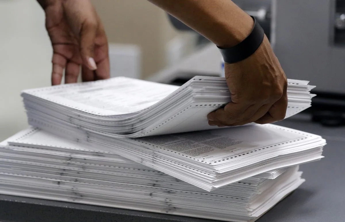 Elections staff load ballots into machine as recounting is underway at the Broward County Supervisor of Elections Office in Lauderhill, Fla., on Nov. 11, 2018. (Joe Skipper/Getty Images)
