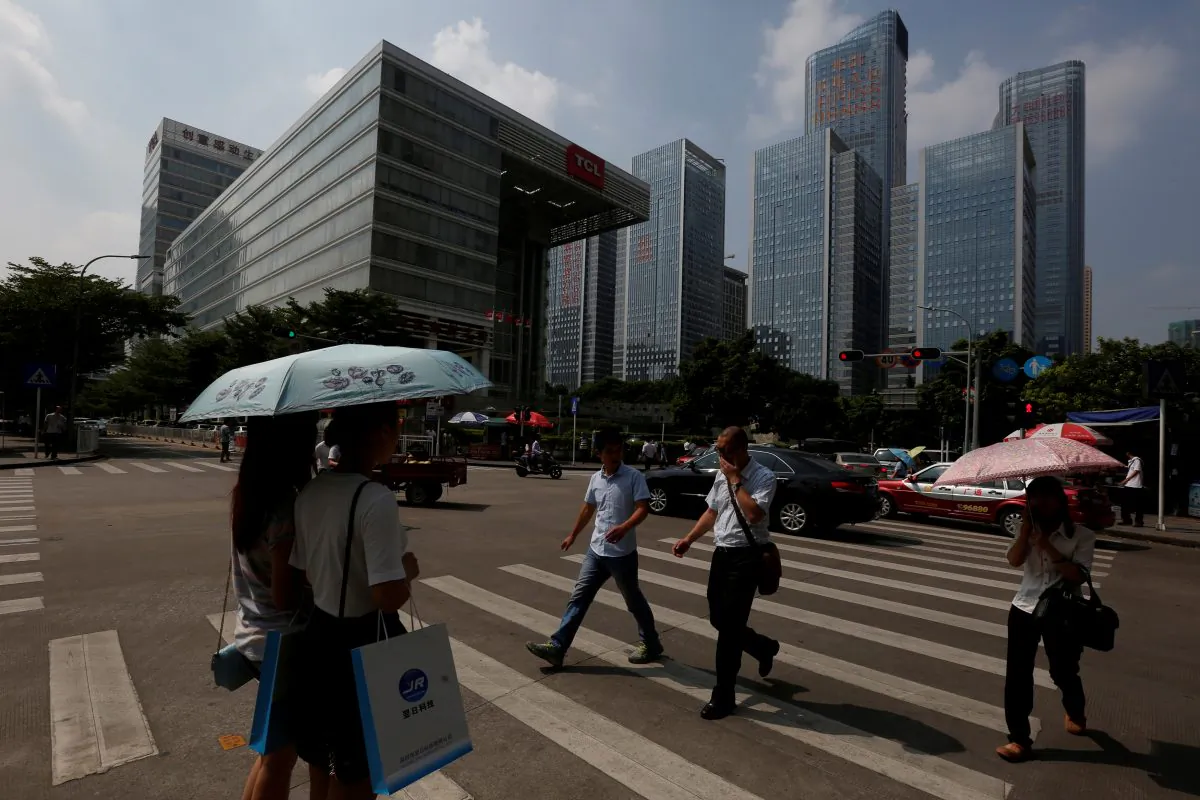 People cross a street at Nanshan district focusing on technology sectors in Shenzhen, China on Sept. 14, 2015. (Bobby Yip/Reuters)