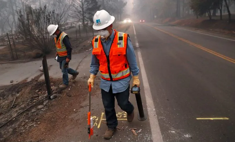 Employees of Pacific Gas & Electric (PG&E) mark gas lines in the aftermath of the Camp Fire. (Reuters/Terray Sylvester)