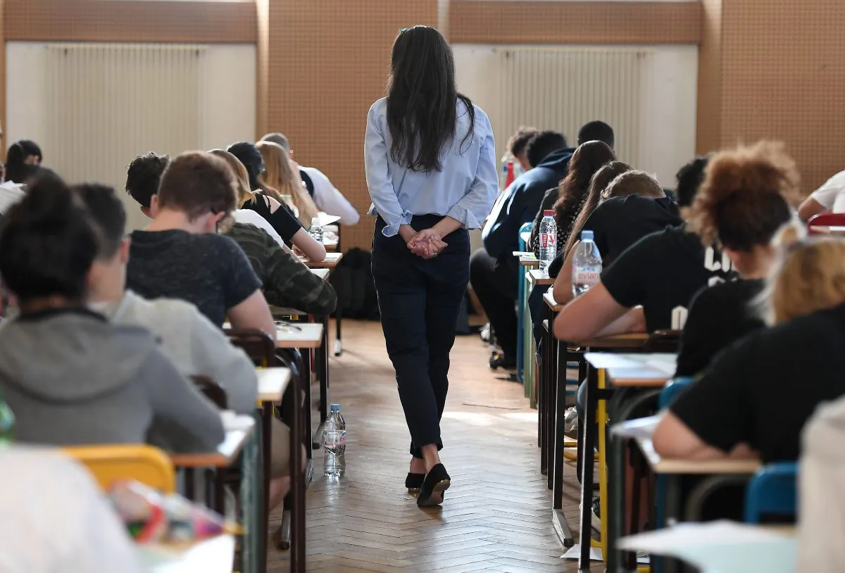 A teacher walks through a classroom during a high school exam in Strasbourg, France on June 18, 2018. (Frederick Florin/AFP/Getty Images)