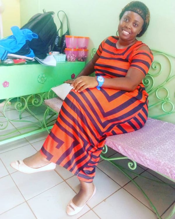 One of the returnees from Mali poses for a photo in her sewing accessories shop in Yaounde, Cameroon.