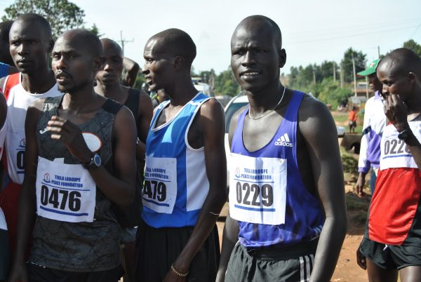 Pur Biel (2-R) stands at the starting point before the 10km road race in Kepnguria, West Pokot County, Kenya.