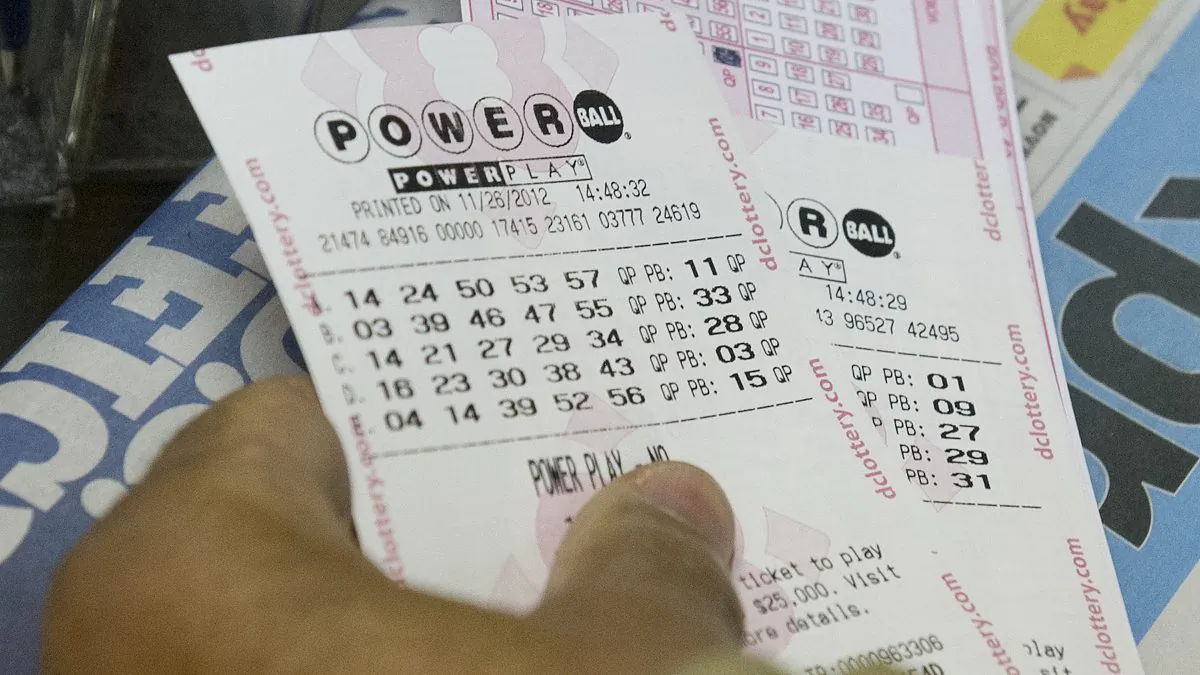 A customer purchases Powerball lottery tickets at a convenience store in Washington on Nov. 26, 2012. (Saul Loeb/AFP/Getty Images)