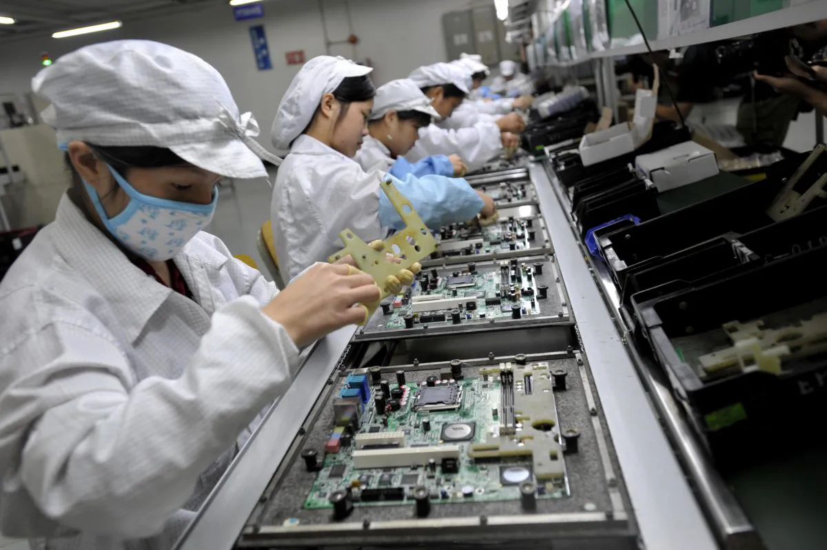 Chinese workers assemble electronic components at the Taiwanese technology giant Foxconn's factory in Shenzhen City, Guangdong Province, China, on May 26, 2010. (AFP/AFP/Getty Images)