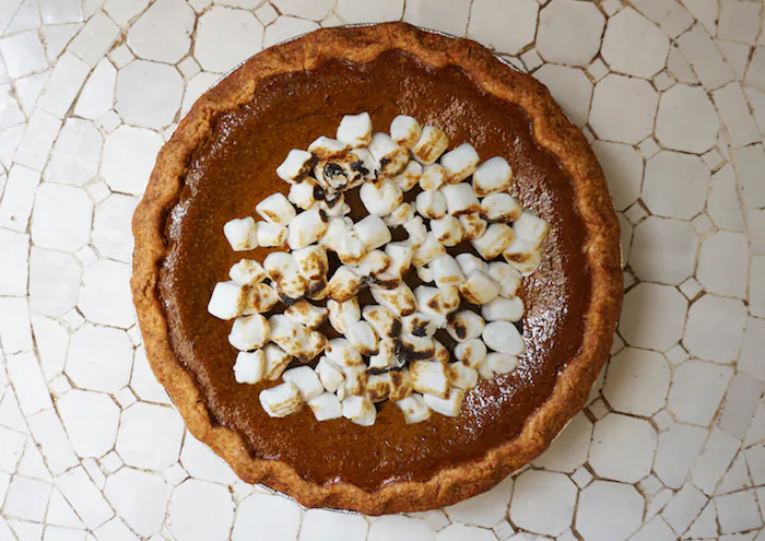 Top your pumpkin pie with coconut whipped cream or toasted vegan marshmallows. (Courtesy of by CHLOE)