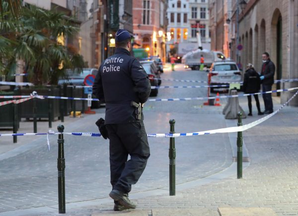 Police keep watch at the scene of a knife stabbing in Brussels