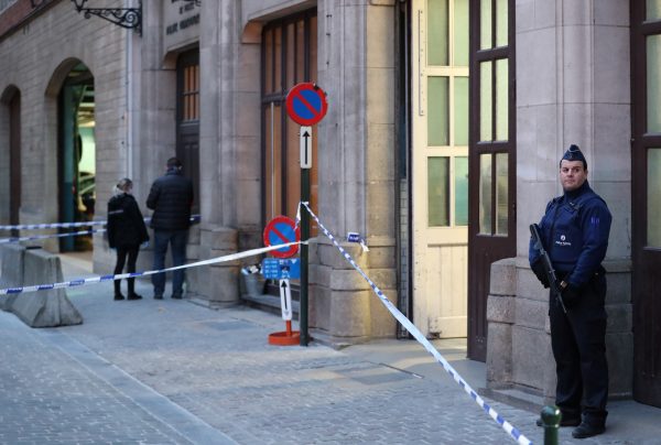 a policeman stands guard at the crime scene