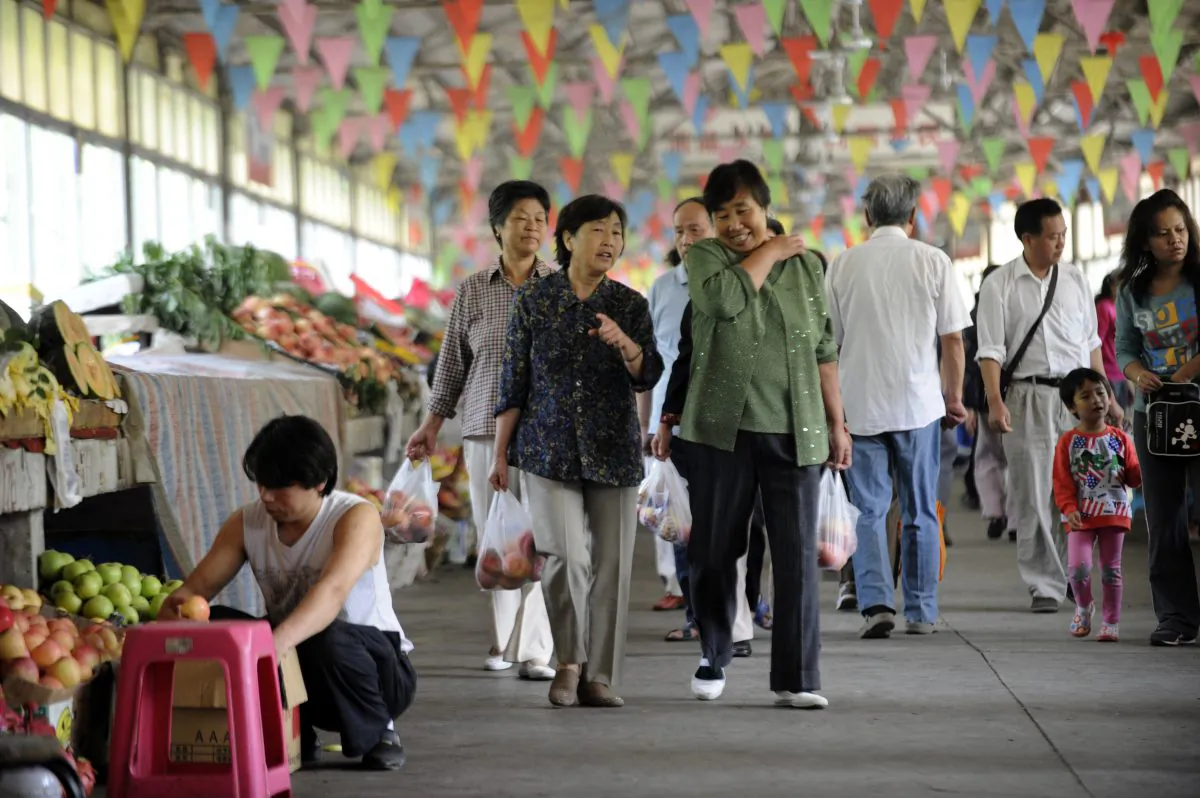 Residents make their way along a market in Beijing on Sept. 7, 2012. (Wang Zhao/AFP/GettyImages)