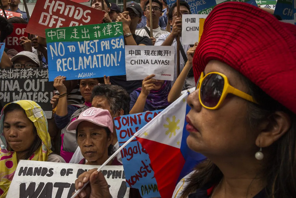 Protesters march on the street chanting and carrying anti-China slogans in the business district of Makati, Philippines on Nov. 30, 2018. (Jes Aznar/Getty Images)