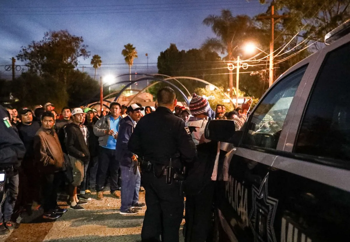 Tijuana municipal police arrest two members of a migrant caravan for alleged marijuana possession at a municipal sports complex in Tijuana, Mexico, on Nov. 17, 2018. (Charlotte Cuthbertson/The Epoch Times)