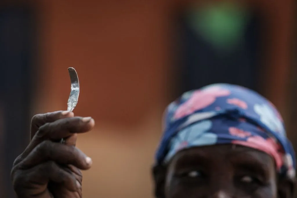 Ex-female genital mutilation (FGM) cutter Monika Cheptilak, who stopped practicing after the country set anti-FGM law in 2010, shows a homemade tool from a nail used for FGM in Uganda on Jan. 31, 2018. (YASUYOSHI CHIBA/AFP/Getty Images)