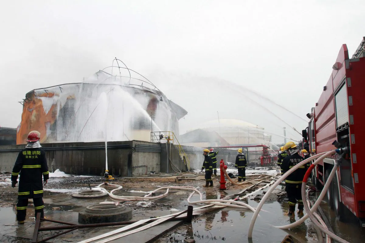 Firefighters douse a chemical tank after a blast at a plant producing paraxylene—a chemical commonly known as PX—in Zhangzhou, Fujian Province, China on April 9, 2015. Almost 30,000 people living near a Chinese chemical plant where a huge fire blazed for a total of nearly 50 hours were evacuated before the flames were finally extinguished. (STR/AFP/Getty Images)