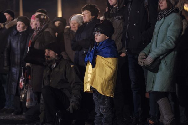 A boy listens as activists and religious leaders speak during a ceremony in Kharkiv, Ukraine.