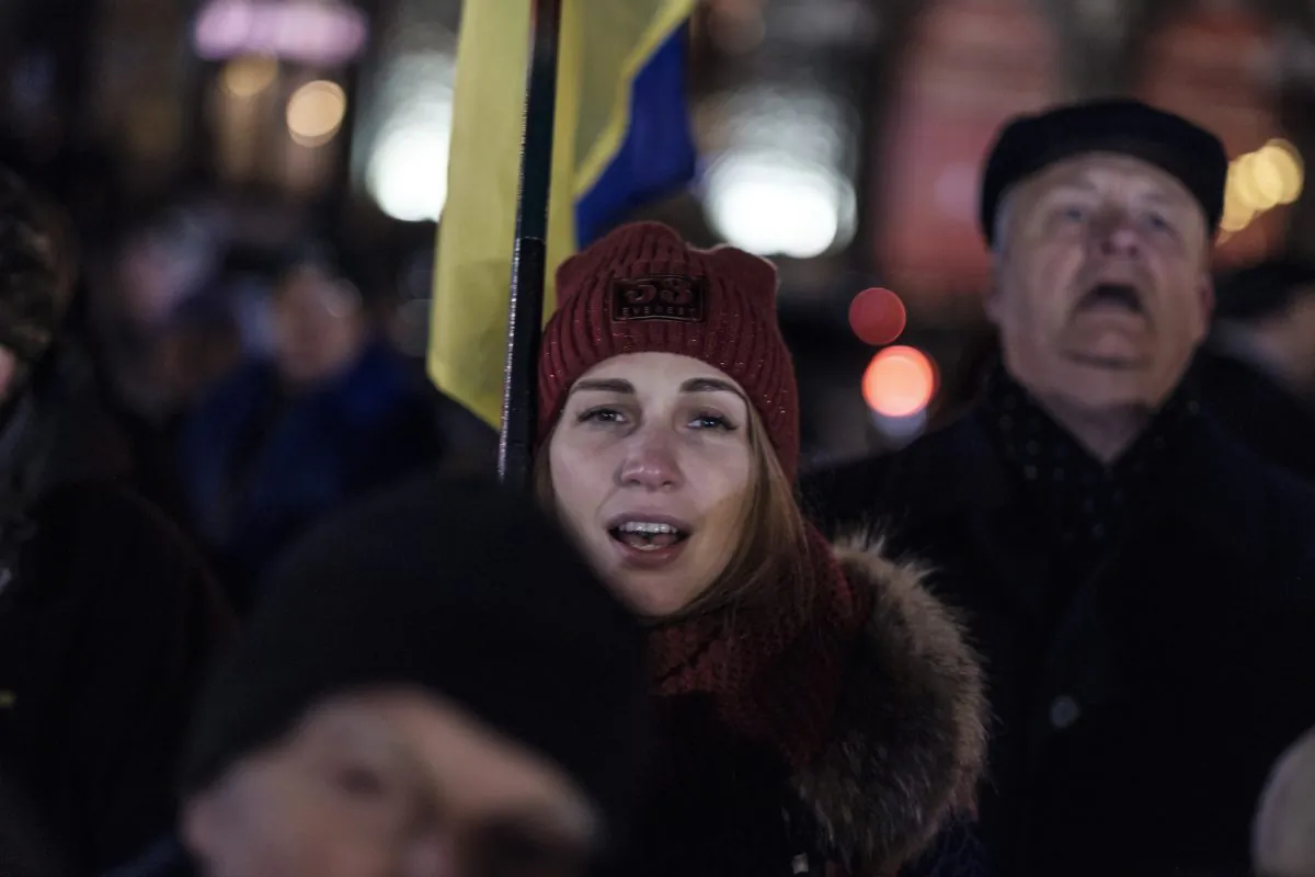 A woman sings along to Ukraine’s national anthem at an event in the eastern city of Kharkiv on Nov. 21, 2018, commemorating five years since the Nov. 2013 protests that resulted in the ouster of President Viktor Yanukovych. (Chris Collison/Special to The Epoch Times)