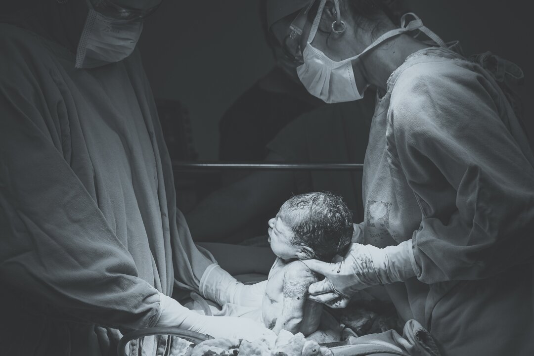 Hospital practices like early infant bathing and antibiotic eye prophylaxis may reduce the amount of beneficial bacteria that babies born in hospitals have. (Patricia Prudente/Unsplash)