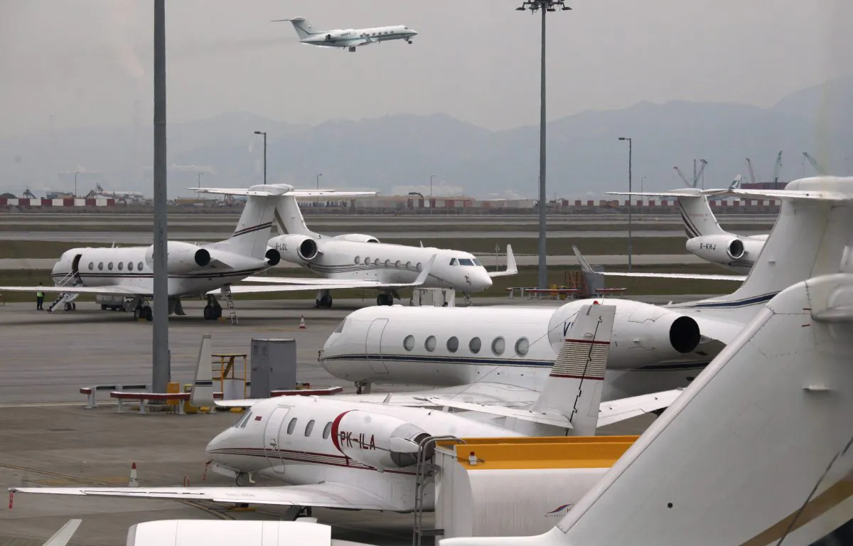 A business jet takes off as others are parked at the Hong Kong Airport on Feb. 17, 2012. (Bobby Yip/Reuters)
