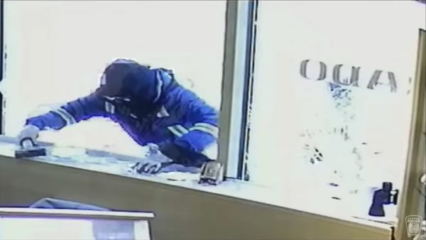 a would-be robber holds a hammer