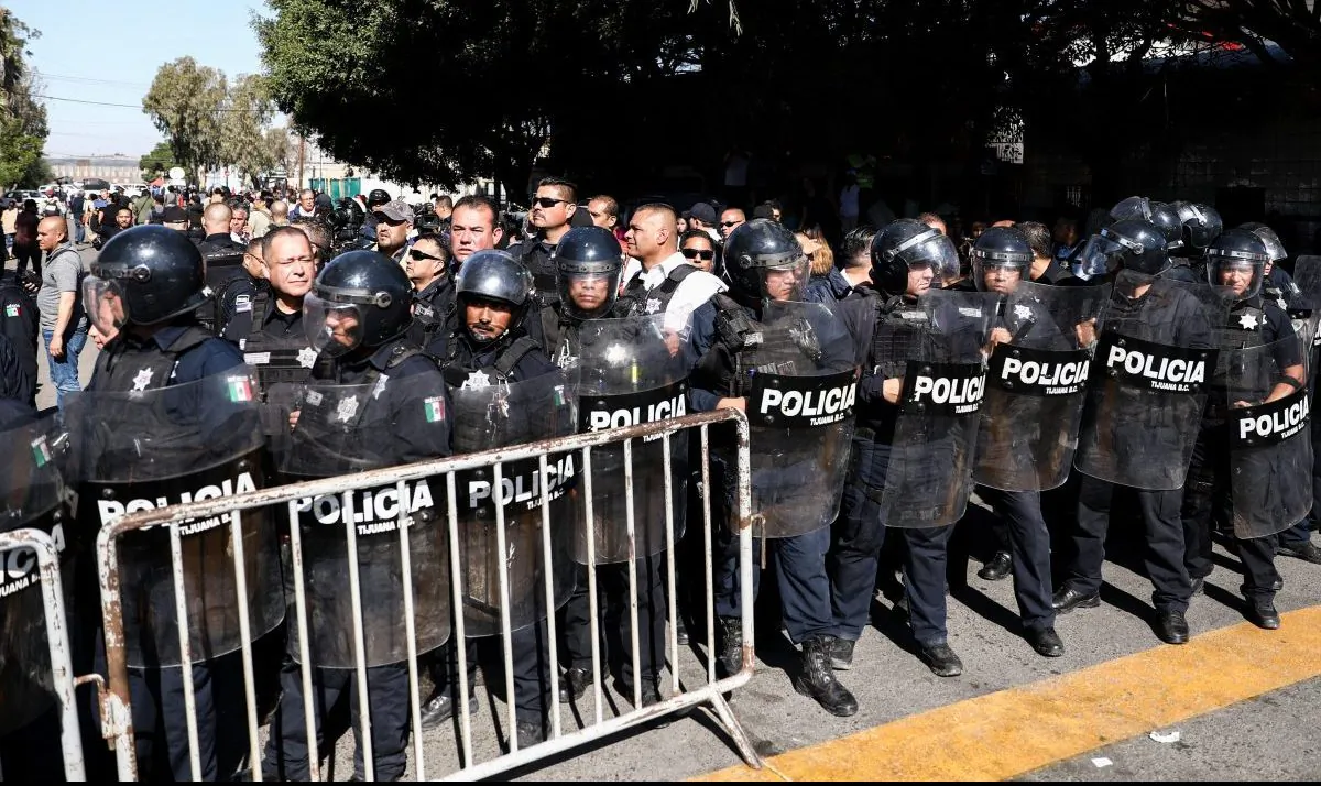 Tijuana riot police form a barrier between the migrant camp and protesting Mexicans in Tijuana, Mexico, on Nov. 18, 2018. (Charlotte Cuthbertson/The Epoch Times)
