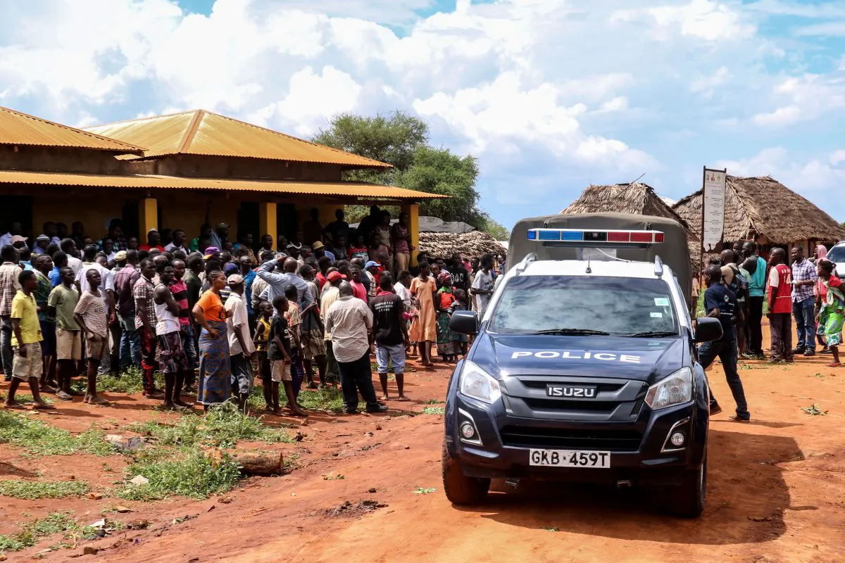 Villagers gather beside a police vehicle as they look at an area where a grenade exploded during an attack by a gang in the coastal Kilifi county, south-east Kenya, on Nov. 21, 2018, during which Silvia Romano, an Italian charity worker was abducted. (Stringer/AFP/Getty Images)