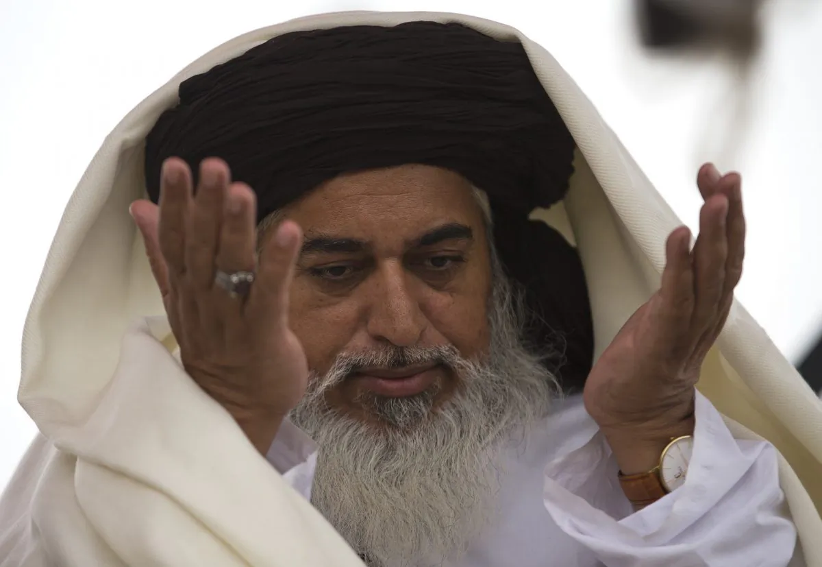 The head of the Pakistani Tehreek-e-Labbaik radical religious party, Khadim Hussain Rizvi prays during a sit-in protest in Islamabad, Pakistan on Nov. 24, 2017. (AP Photo/B.K. Bangash, file)