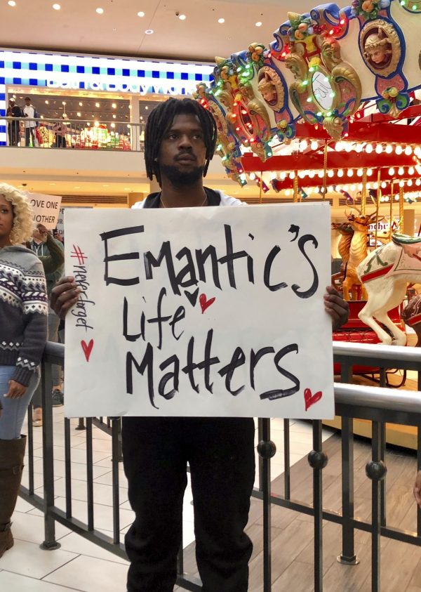 Elijah King holds a sign