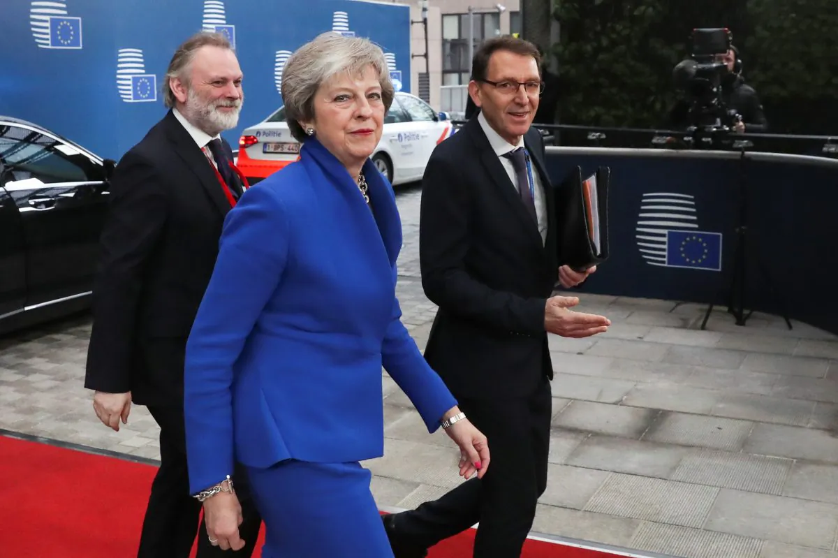 Britain's Prime Minister Theresa May arrives with Britain's Permanent Representative to the EU Tim Barrow at an extraordinary EU leaders summit to finalise and formalise the Brexit agreement in Brussels, Belgium, on Nov. 25, 2018. (Yves Herman/Pool/Reuters)