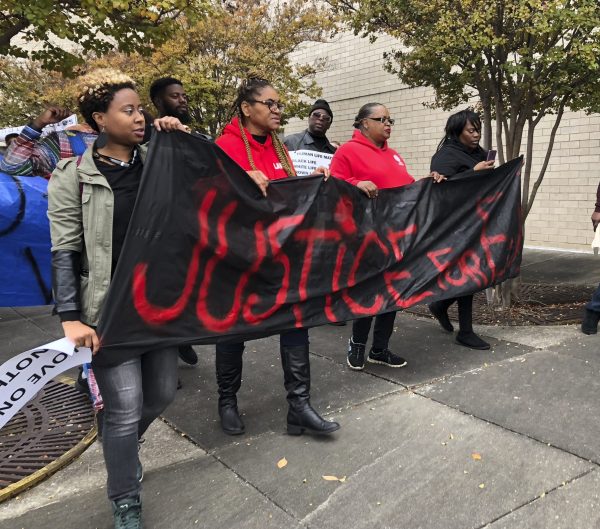 Protestors carry a sign