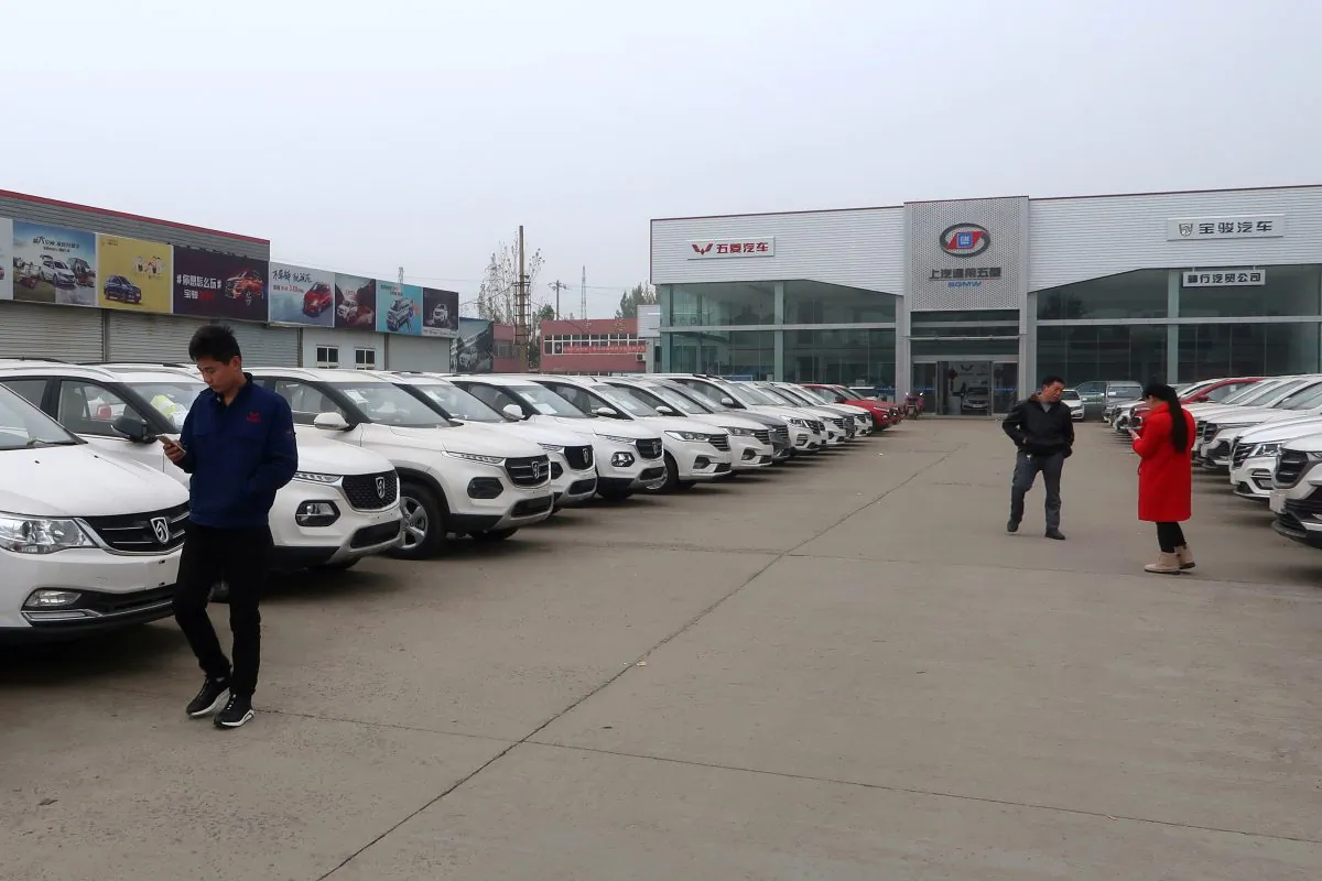 Dealers and customers are seen next to cars at a SAIC-GM-Wuling Baojun dealership in Pingdingshan, Henan Province, China on Nov. 15, 2018. (Yilei Sun/Reuters)