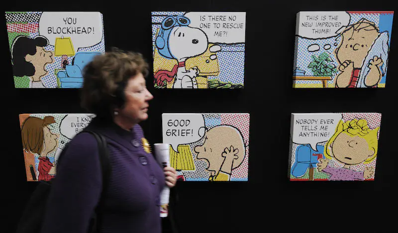 A visitor walks past a display of "Peanuts" cartoons by the late Charles Schulz at the Frankfurt Book Fair, on Oct. 15, 2008. (John Macdougall/AFP/Getty Images)