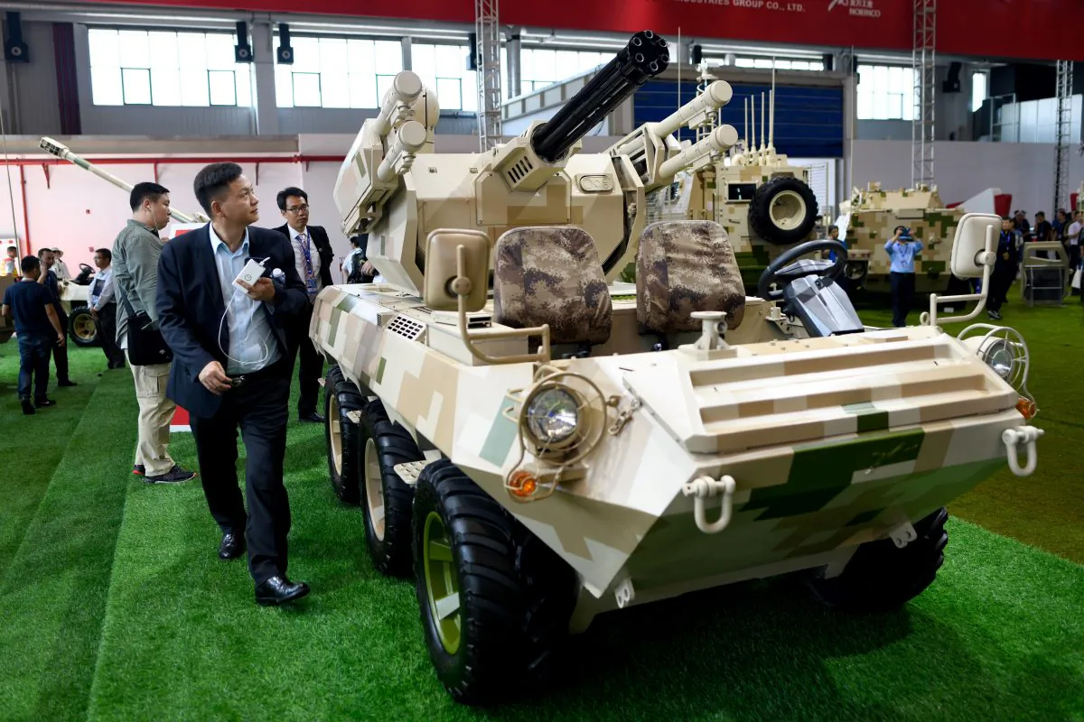 Visitors look at a "wheeled combat vehicle" on display at the 2018 Airshow China in Zhuhai, China, on Nov. 7, 2018. (WANG ZHAO/AFP/Getty Images)