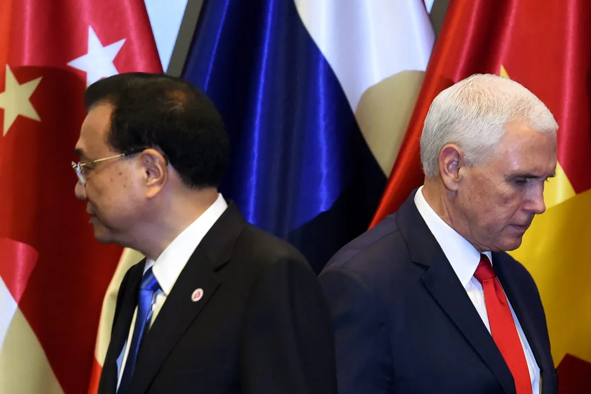 U.S. Vice President Mike Pence (R) and Chinese Premier Li Keqiang leave the stage after posing for a group photo before the start of the 13th East Asia summit plenary session on the sidelines of the 33rd Association of Southeast Asian Nations (ASEAN) summit in Singapore on Nov. 15, 2018. (ROSLAN RAHMAN/AFP/Getty Images)