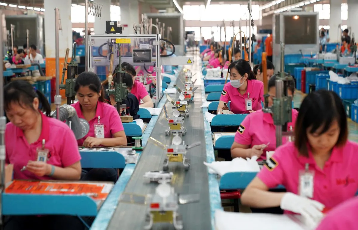 Employees work at a production line assembling scale models of the moon rover for China's Chang'e 4 lunar probe, at a factory in Dongguan, Guangdong Province, China on Nov. 16, 2018. (Reuters)