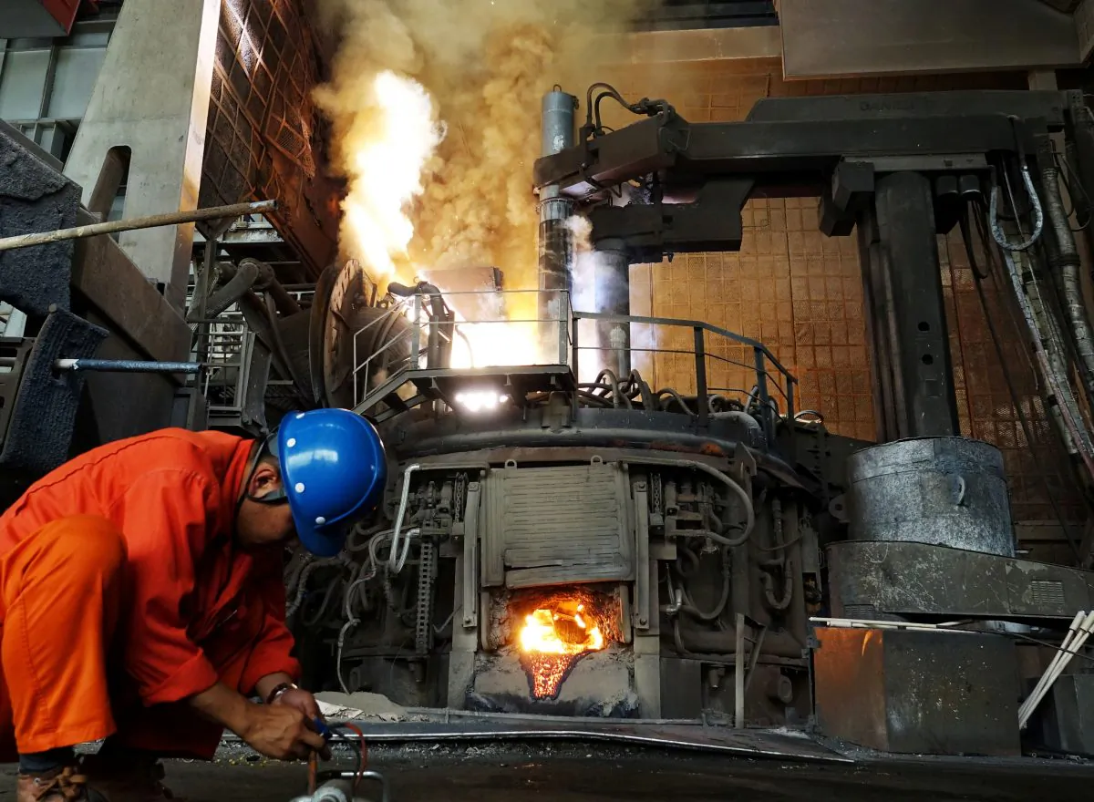 A man works in front of a furnace at a steel plant of Dalian Special Steel Co Ltd. in Dalian, Liaoning Province, China on June 20, 2018. (Reuters)