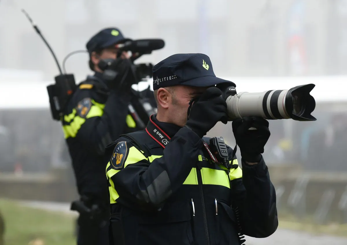 Dutch Policeman take pictures of the supporters of Dutch far-right Freedom Party leader (Partij Voor De Vrijheid - PVV) Geert Wilders as he officially launches his parliamentary election campaign in Spijkenisse on February 18, 2017.(JOHN THYS/AFP/Getty Images)