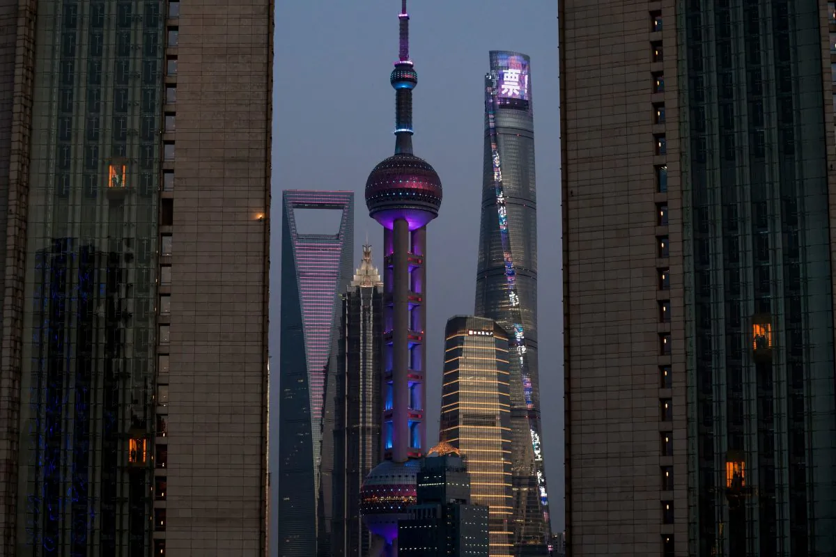 People use hotel elevators (L and R) next to the skyline of Pudong, the financial district of Shanghai, China on April 7, 2018. (Johannes Eisele/AFP/Getty Images)