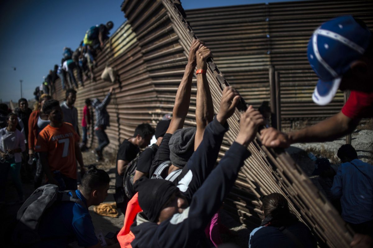 migrants-caravan-border-fance-tijuana-mexico-1065207670-1200x798