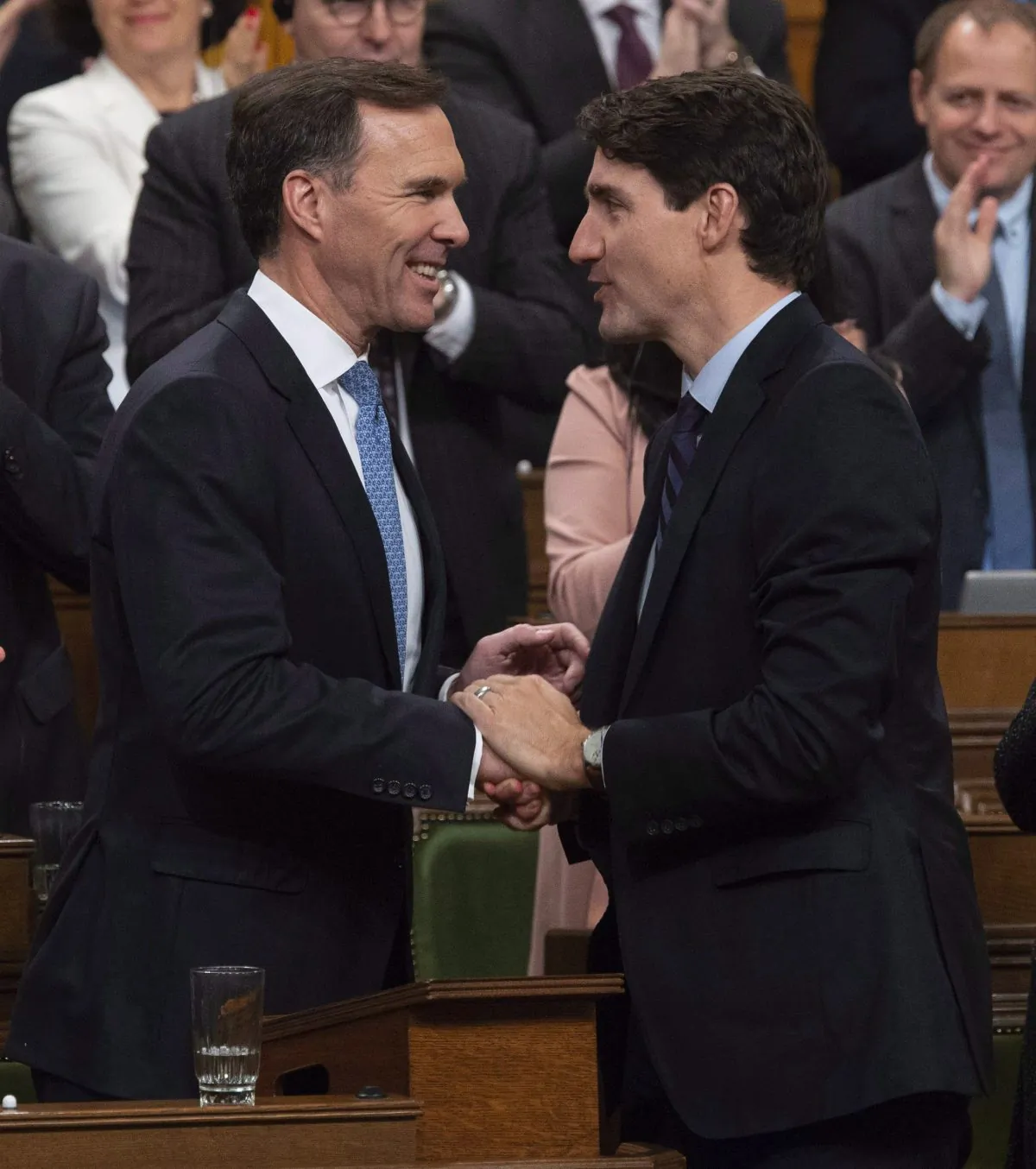 Canadian Prime Minister Justin Trudeau (R) congratulates Minister of Finance Bill Morneau following the fall fiscal update in the House of Commons, in Ottawa Nov. 21, 2018. (The Canadian Press/Adrian Wyld)