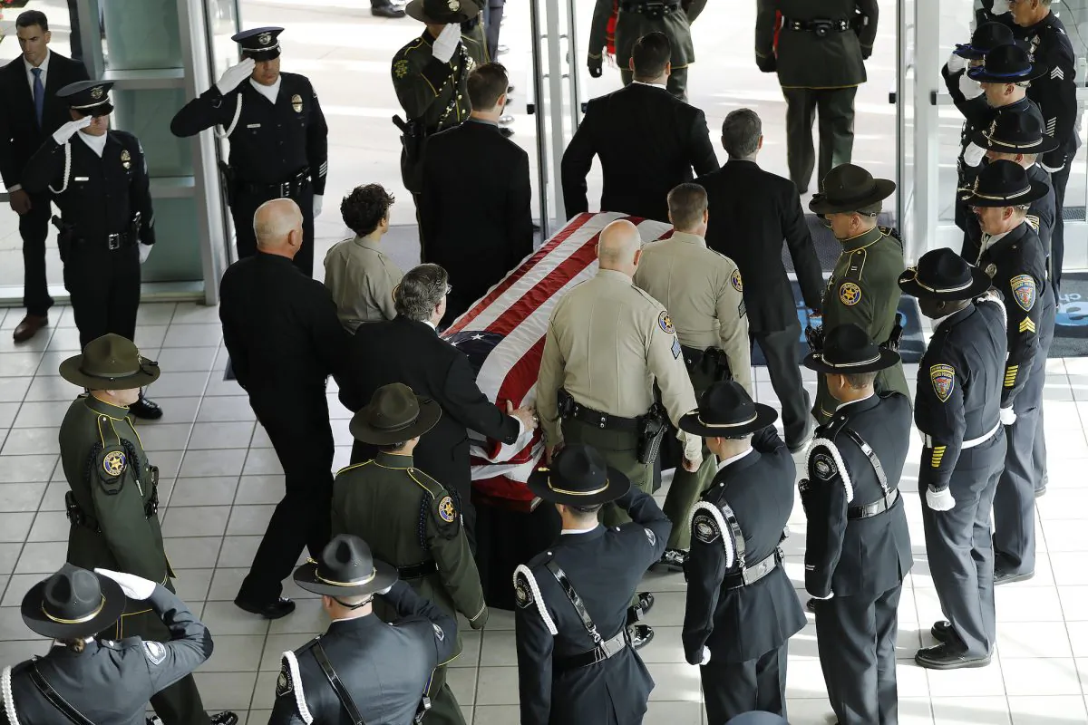The casket with the body of Ventura County Sheriff Sgt. Ron Helus is carried out after a memorial service at Calvary Community Church in Westlake Village, Calif., on Nov. 15, 2018. (Al Seib / Los Angeles Times)