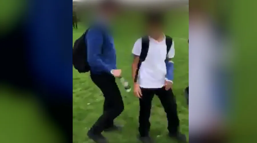 A video still shows the moment a boy identified as Jamal, wearing a cast, is approached by a boy who then strangles him at Almondbury Community School in West Yorkshire, England, on Oct. 25, 2018. (Screenshot/Twitter)