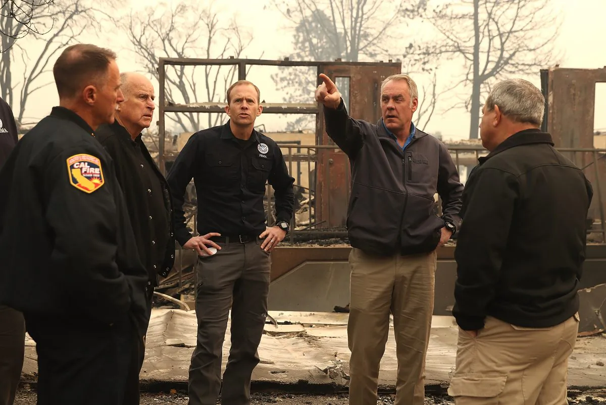 California Governor Jerry Brown, FEMA Administrator Brock Long, and U.S. Secretary of the Interior Ryan Zinke tour a school burned by the Camp Fire on Nov. 14, 2018 in Paradise, Calif. (Photo by Justin Sullivan/Getty Images)