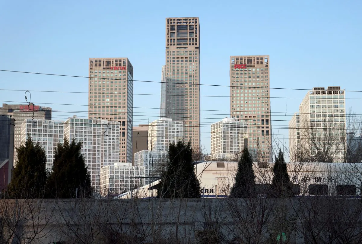 A CRH (China Railway High-speed) bullet train runs past Beijing's central business area on Dec. 13, 2017. (Jason Lee/Reuters)