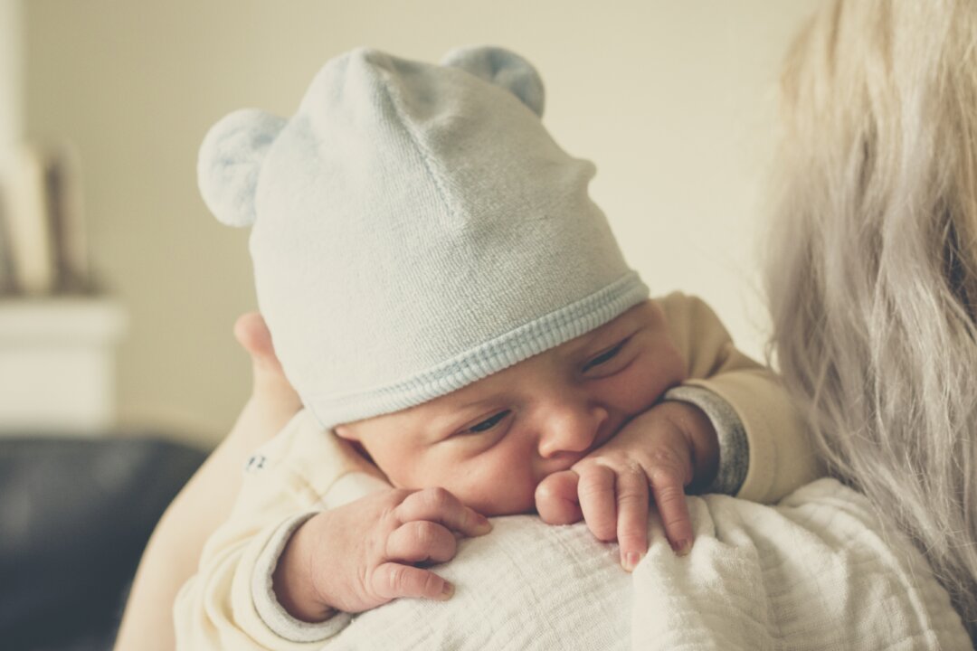 An undated stock photo of a mother holding a baby. (Echo Grid/Unsplash)