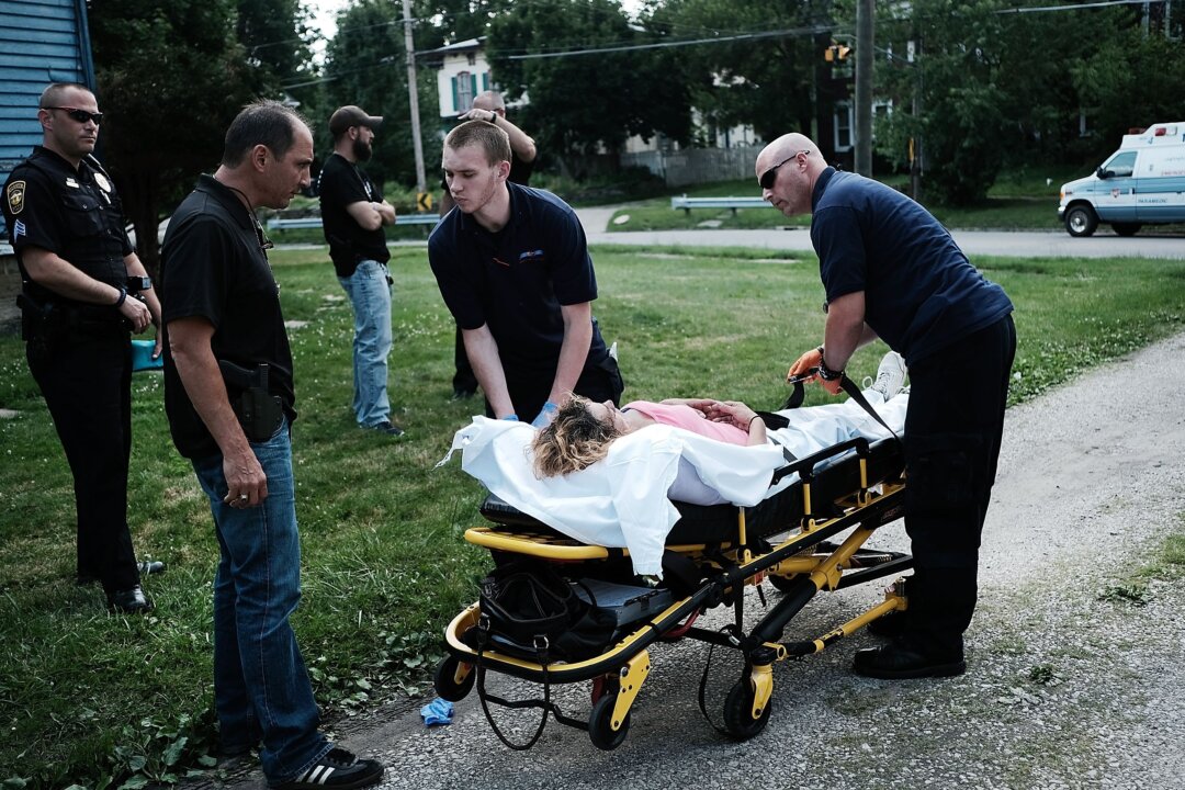 Medical workers and police treat a woman who has overdosed on heroin in Warren, Ohio, on July 14, 2017. (Spencer Platt/Getty Images)